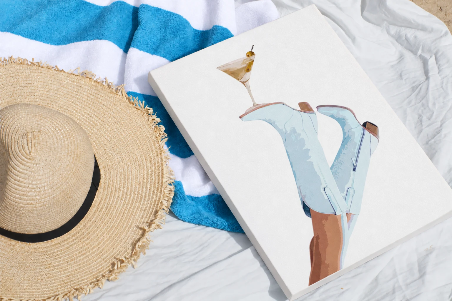 Blue Cowgirl Boots Canvas detail, photographed with a summer hat and striped towel