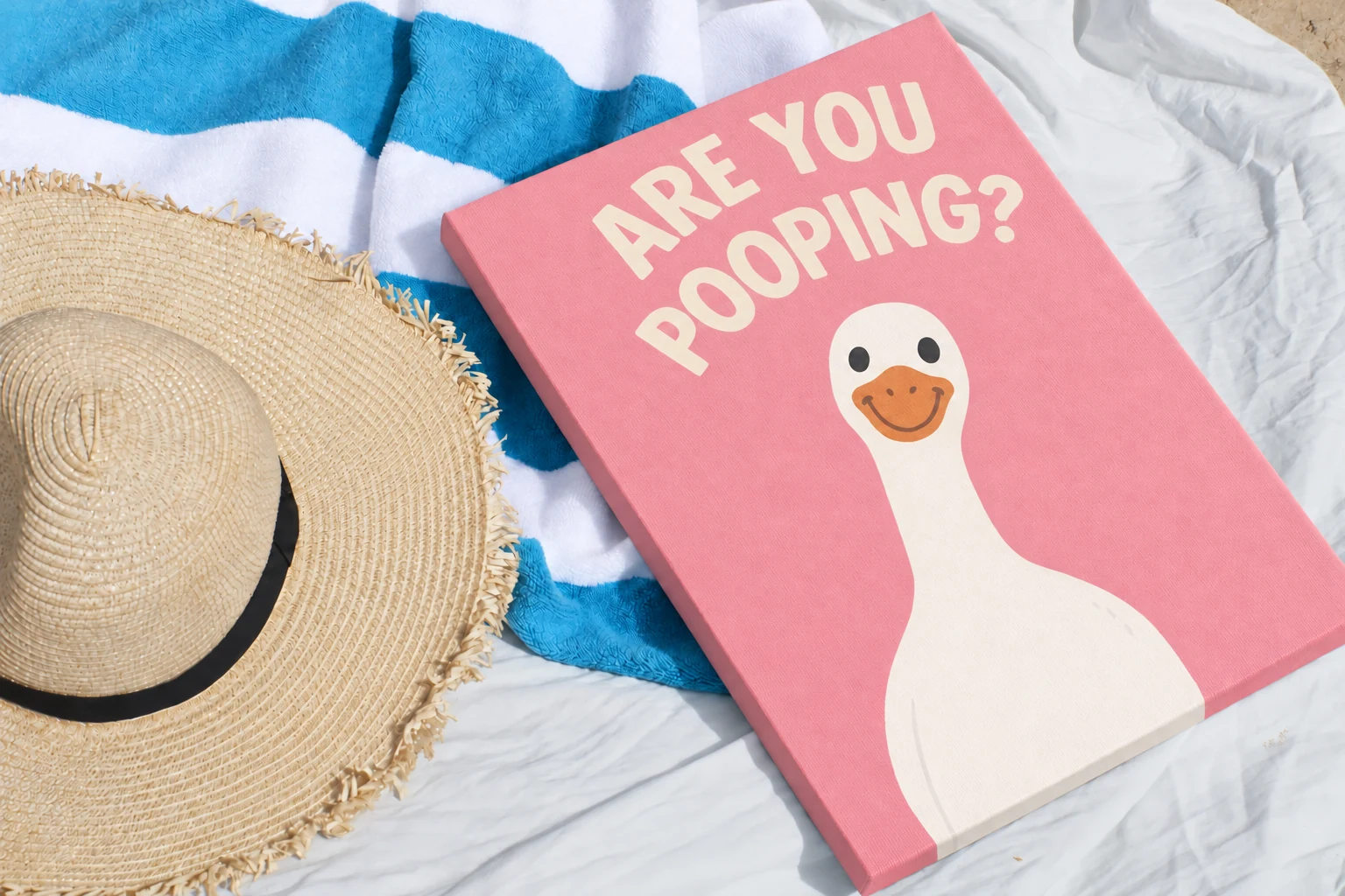 Silly Goose Canvas detail, photographed with a summer hat and striped towel